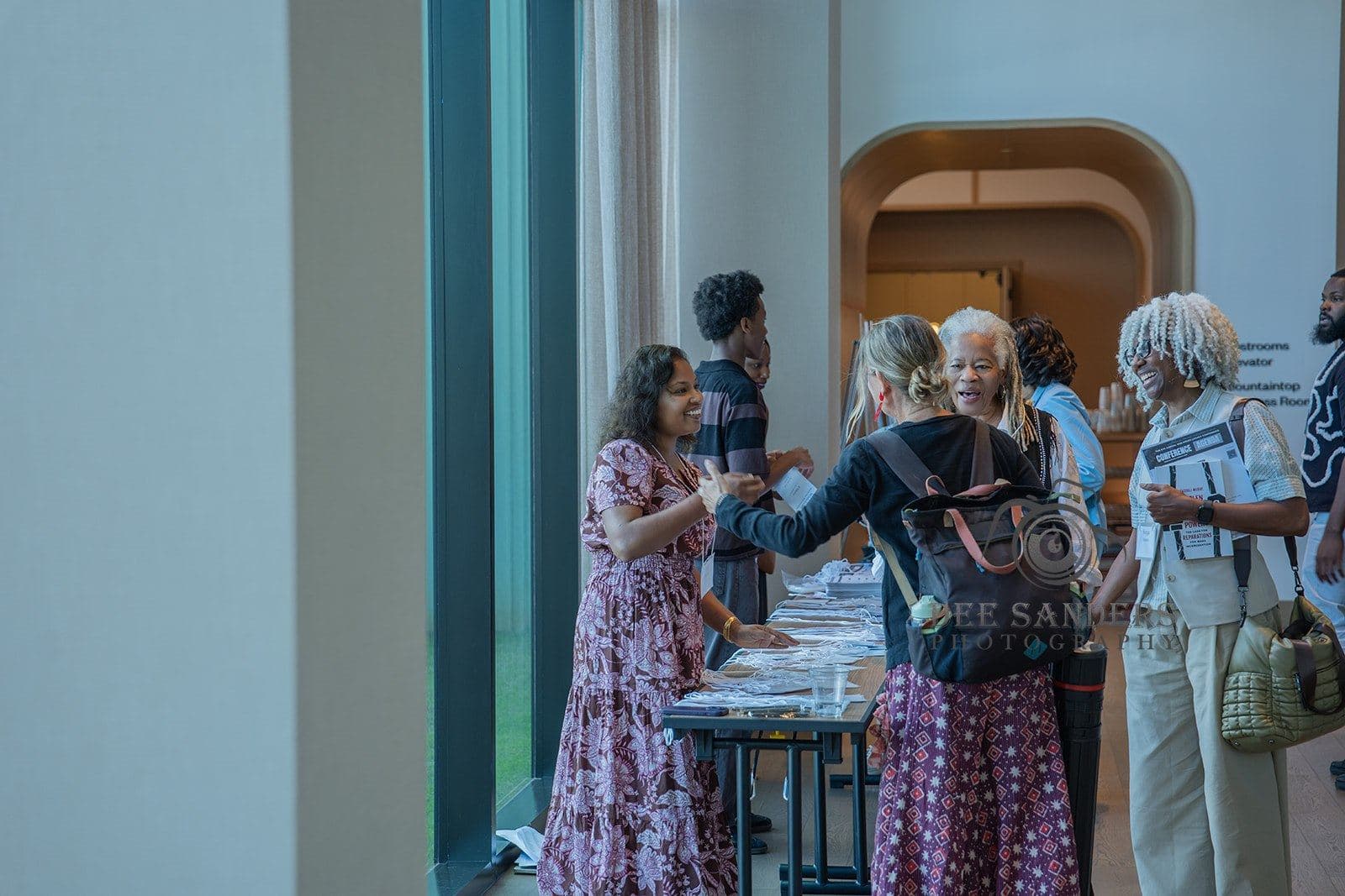 Guests gathering around the registration tables
