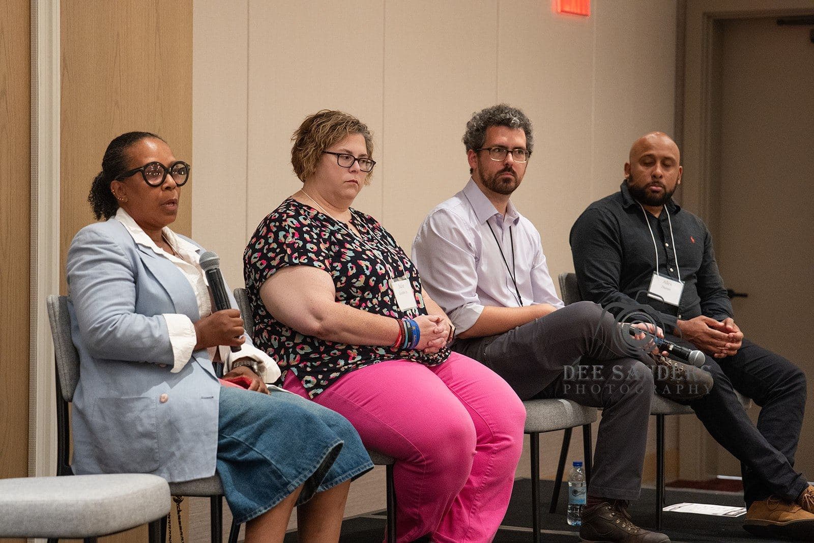 Panelists in conversation on stage