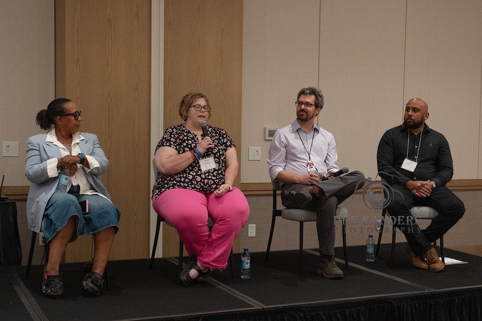 Panel on stage before a packed audience