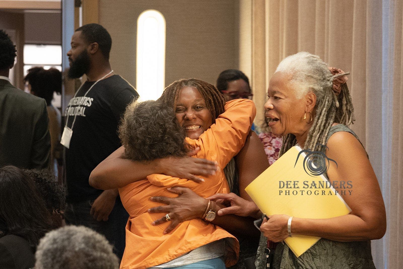 Two attendees embracing at the Saturday gathering