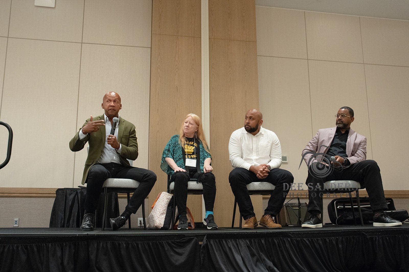 Four panelists in conversation on stage