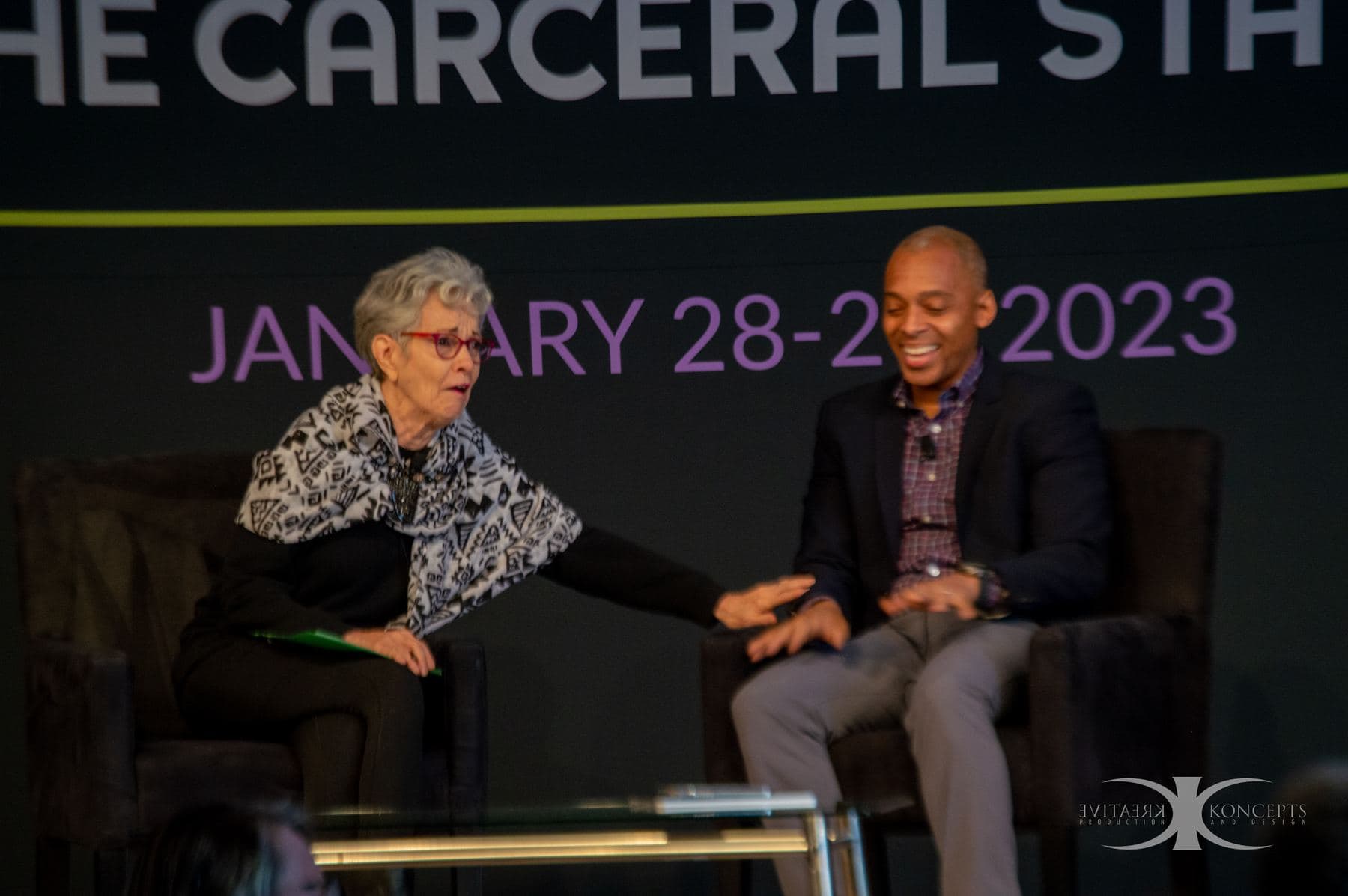 Two speakers in conversation on stage