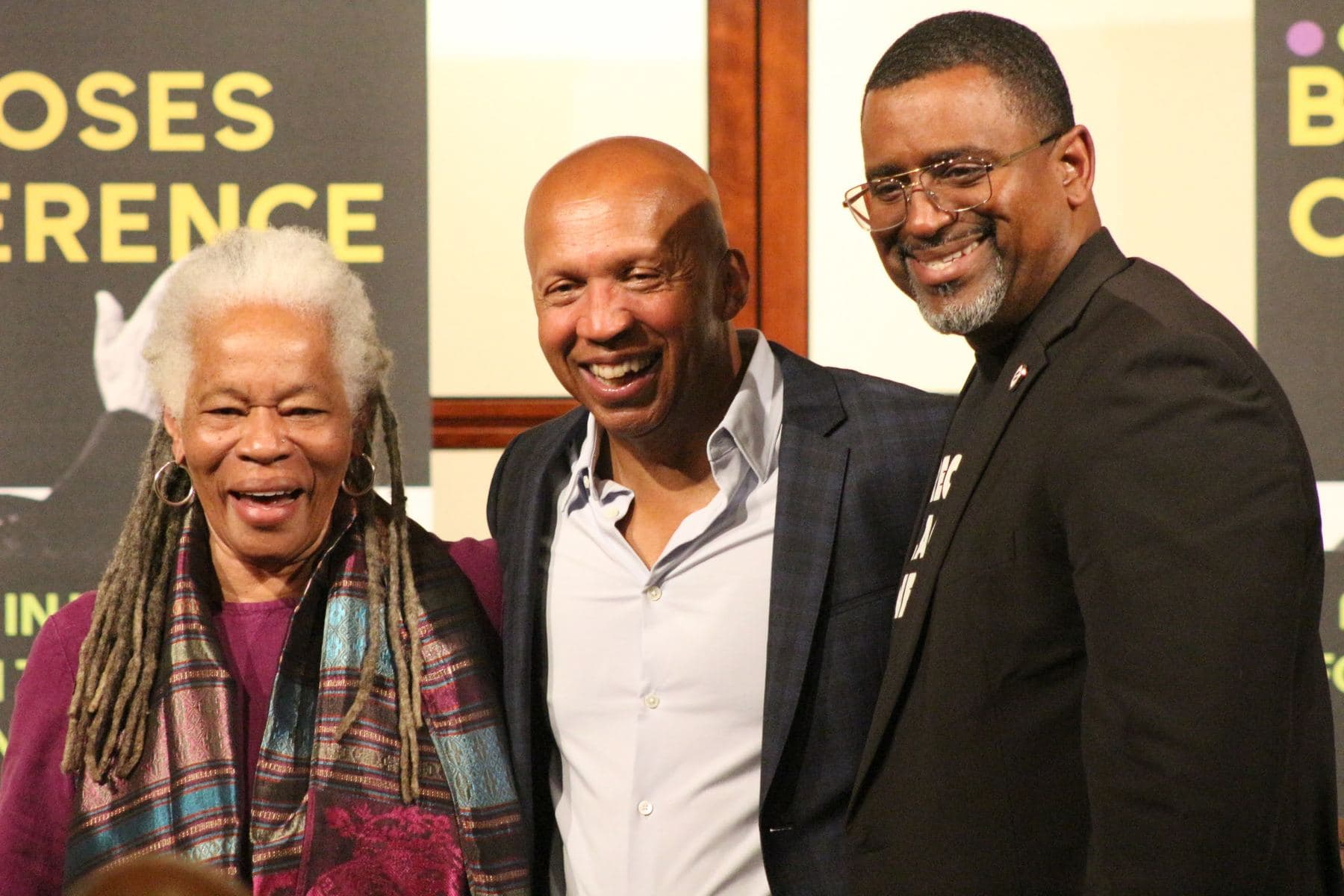 Three attendees smiling together