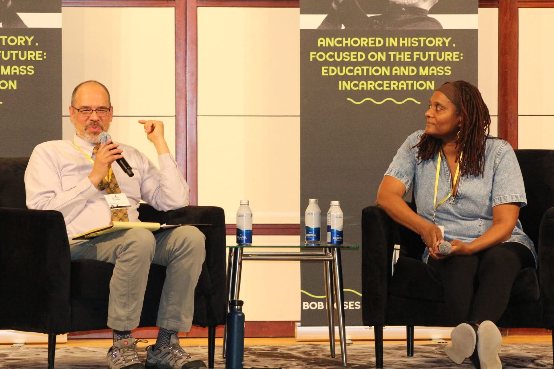 Two speakers in conversation on stage