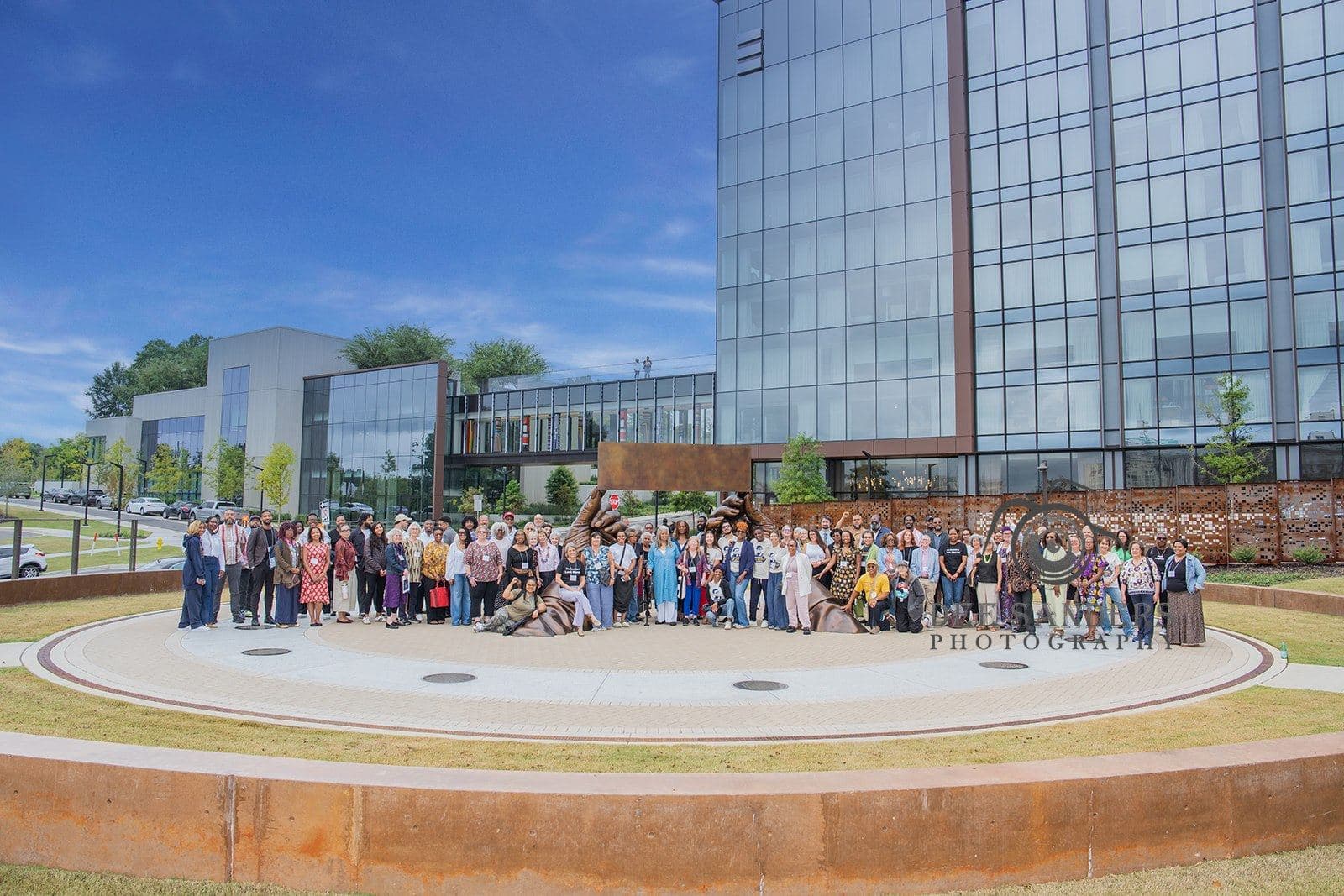 Conference participants gathered for a group photo outside